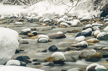 Image showing  Snow-covered mountain river shot with long exposure