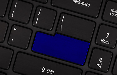 Image showing Laptop computer keyboard with blank blue button