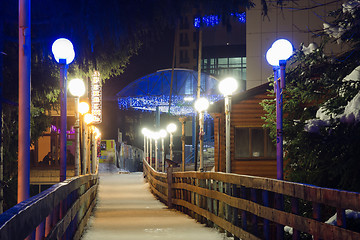 Image showing Dombay, Russia - February 7, 2015: Night view of winter hanging cable-stayed bridge over the river Amanauz