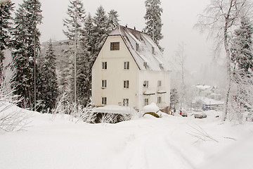 Image showing Dombay, Russia - February 7, 2015: The yard facade of the snow-covered hotel \