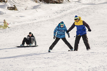 Image showing Dombay, Russia - February 7, 2015: The instructor teaches how to ski on snow downhill ski training on the resort Dombay