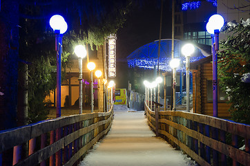 Image showing Dombay, Russia - February 7, 2015: Night view of winter hanging cable-stayed bridge over the river Amanauz