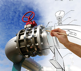 Image showing man\'s hand draws a design of factory combined with photo of mode