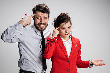 Image showing The sad business man and woman conflicting on a gray background