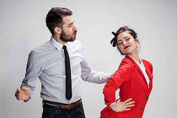 Image showing The business man and woman communicating on a gray background