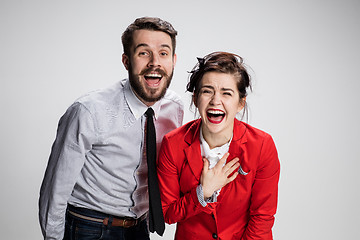 Image showing The business man and woman laughing on a gray background