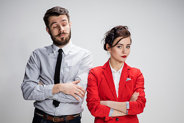 Image showing The sad business man and woman conflicting on a gray background