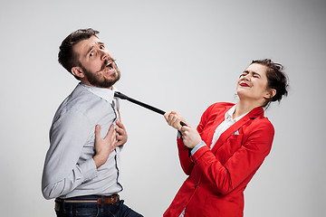 Image showing The sad business man and woman conflicting on a gray background