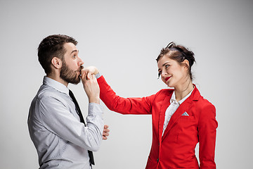 Image showing The business man and woman communicating on a gray background