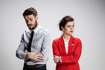 Image showing The sad business man and woman conflicting on a gray background