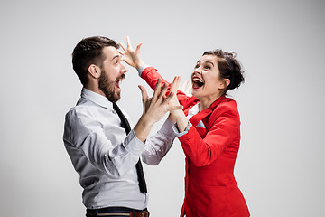 Image showing The business man and woman laughing on a gray background