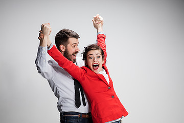 Image showing The business man and woman laughing on a gray background