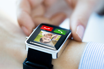 Image showing close up of hands with incoming call on smartwatch