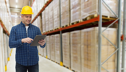 Image showing happy businessman with tablet pc at warehouse