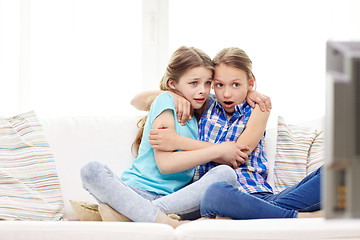 Image showing scared little girls watching horror on tv at home