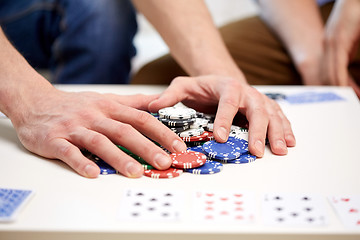 Image showing hands with casino chips making bet or taking win