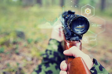 Image showing close up of soldier or sniper with gun in forest