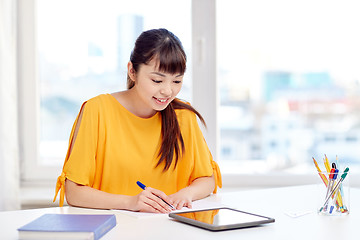 Image showing happy asian woman student with tablet pc at home