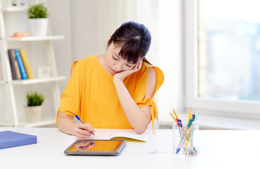 Image showing bored asian woman student with tablet pc at home