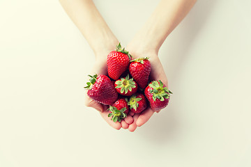 Image showing close up of woman hands holding strawberries