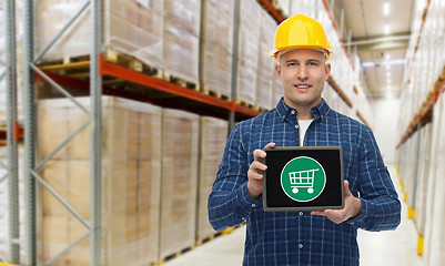 Image showing happy businessman with tablet pc at warehouse