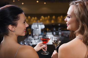 Image showing happy women with drinks at night club bar