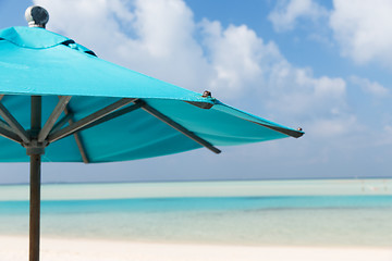 Image showing parasol over blue sky and beach