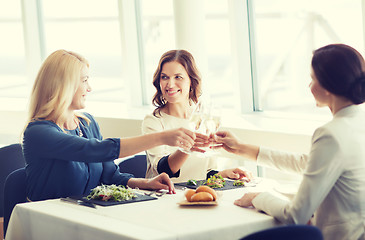 Image showing happy women drinking champagne at restaurant