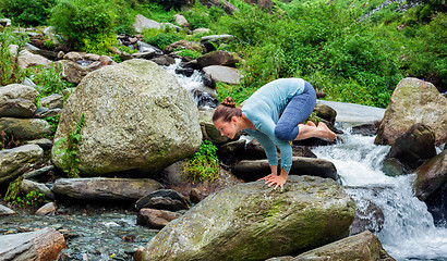 Image showing Woman doing Kakasana asana arm balance outdoors