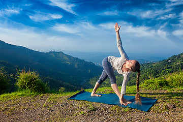 Image showing Woman doing Ashtanga Vinyasa yoga asana Parivrtta trikonasana