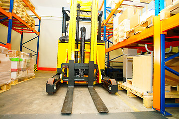 Image showing Forklift, shelves and racks with pallets in distribution warehou