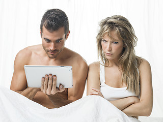 Image showing uncommunicative couple on bed in white 