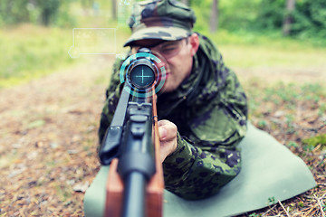 Image showing close up of soldier or sniper with gun in forest