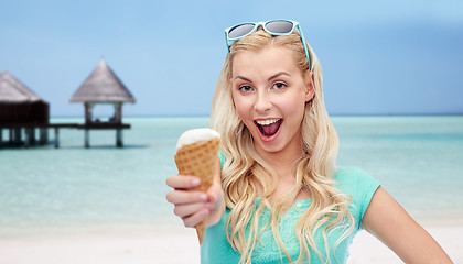 Image showing happy woman in sunglasses with ice cream on beach