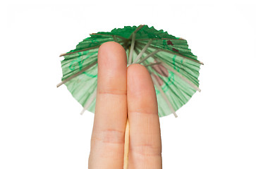 Image showing close up of two fingers with cocktail umbrella