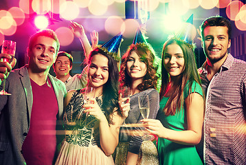 Image showing smiling friends with glasses of champagne in club