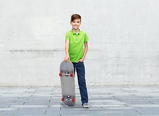 Image showing happy boy with skateboard over street background