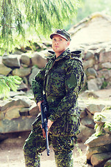 Image showing young soldier or hunter with gun in forest