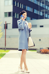 Image showing happy businesswoman calling on smartphone in city 