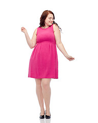 Image showing happy young plus size woman dancing in pink dress