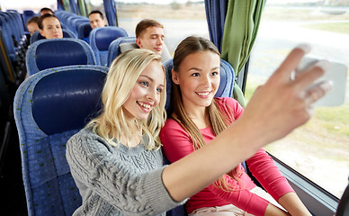 Image showing women taking selfie by smartphone in travel bus