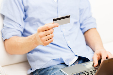 Image showing close up of man with laptop and credit card