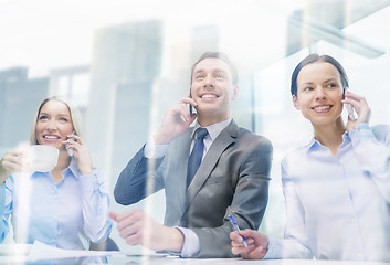 Image showing business team with smartphones having conversation