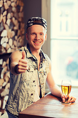 Image showing happy man with beer showing thumbs up at bar