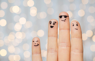 Image showing close up of four fingers with smiley faces