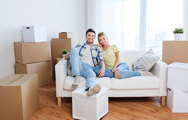 Image showing happy couple with big cardboard boxes at new home