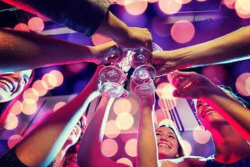 Image showing smiling friends with glasses of champagne in club