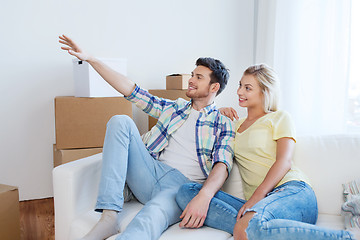 Image showing couple with boxes moving to new home and dreaming