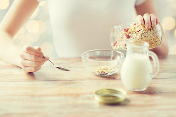 Image showing close up of woman eating muesli for breakfast