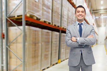 Image showing happy man in suit and tie over warehouse